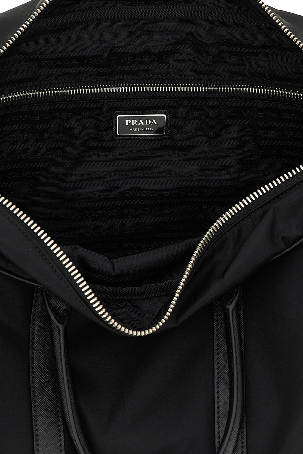 Interior of Prada travel bag with metal logo plaque