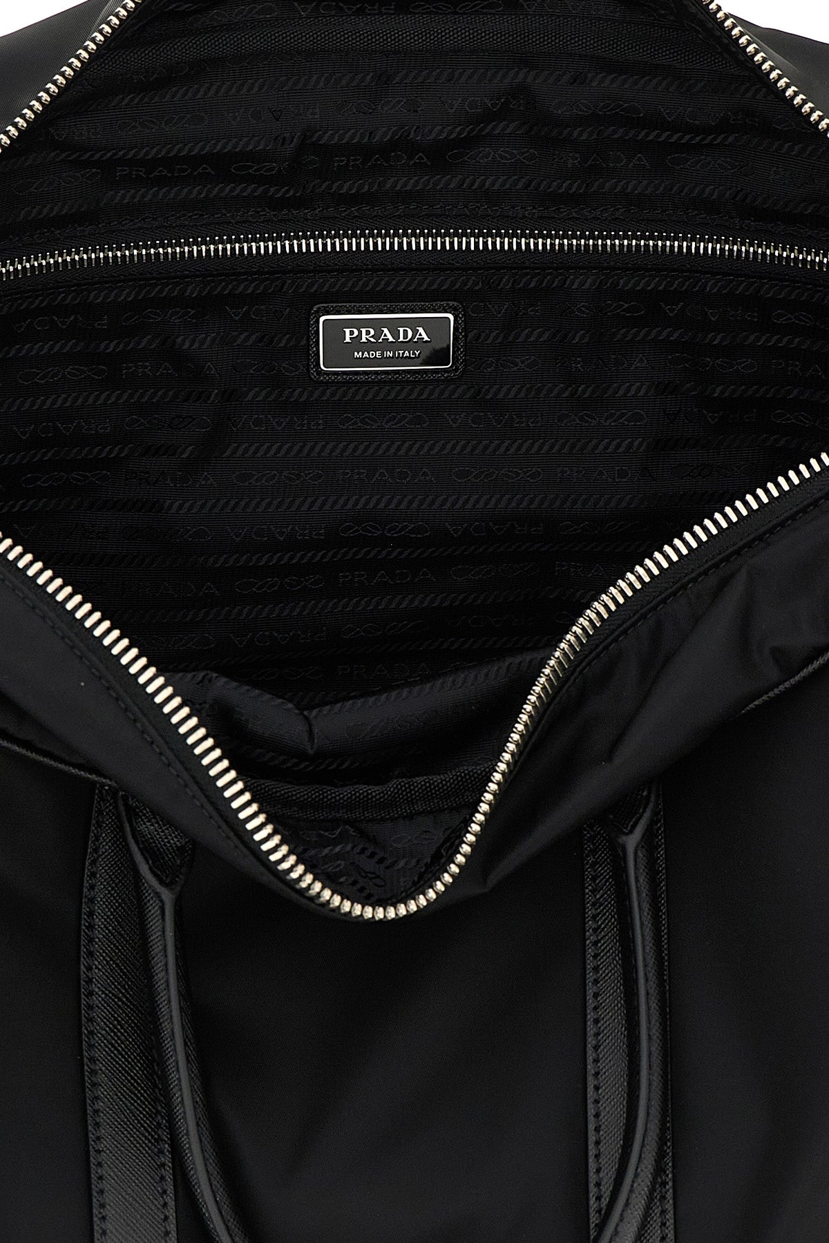 Interior of Prada travel bag with metal logo plaque